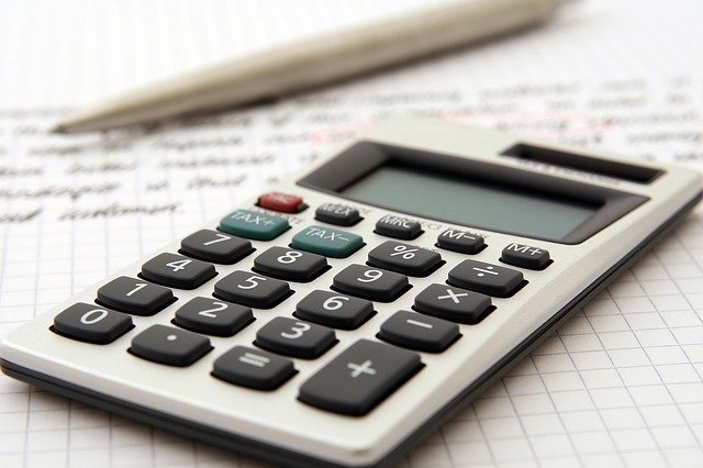A calculator and a pen on a piece of paper